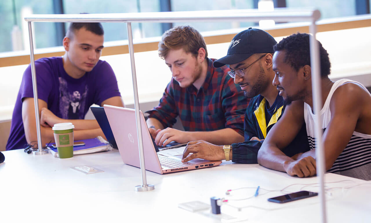 students at a library study table